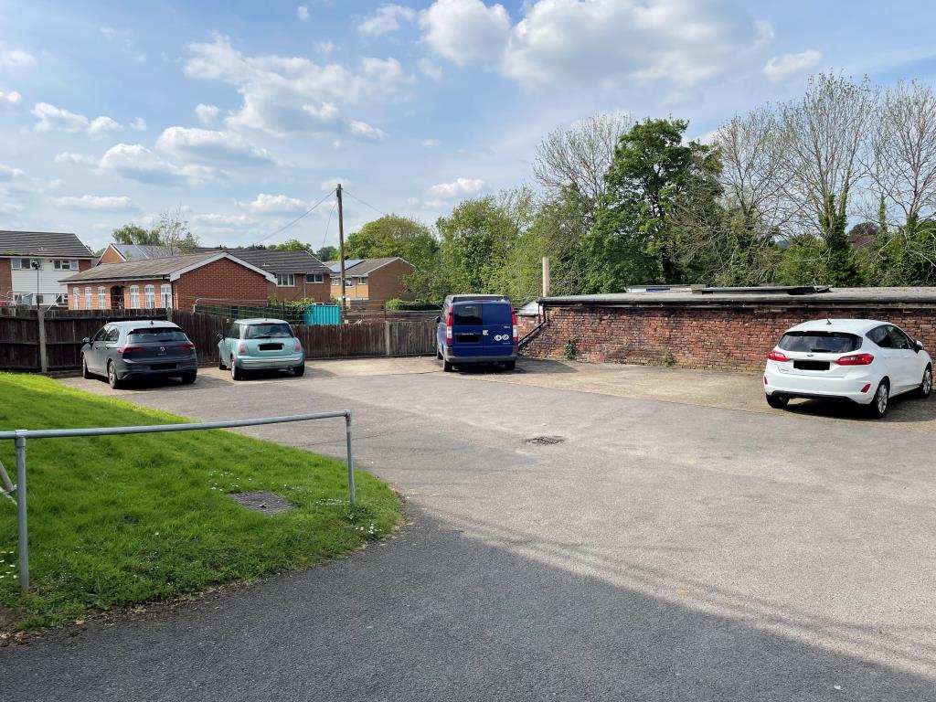 Lot: 151 - TWO-BEDROOM FLAT WITH PARKING - rear parking area showing allocated space and driveway